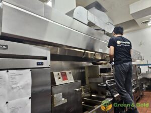 a man cleaning a kitchen hood