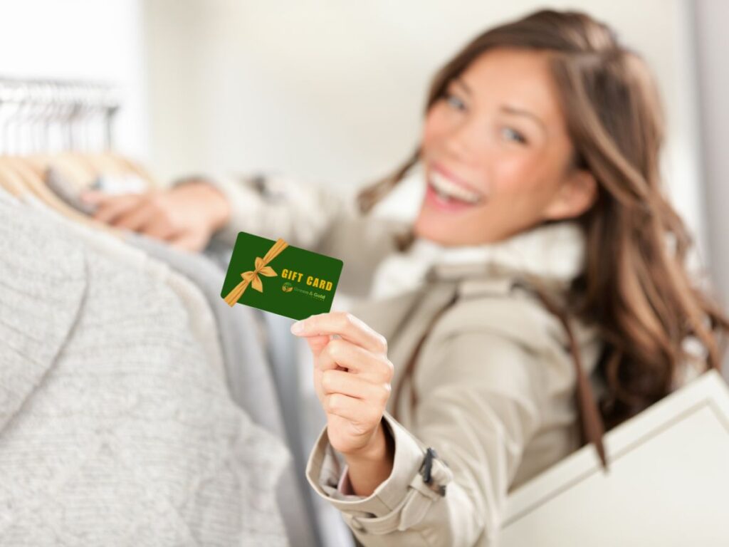 a girl holding gift cards